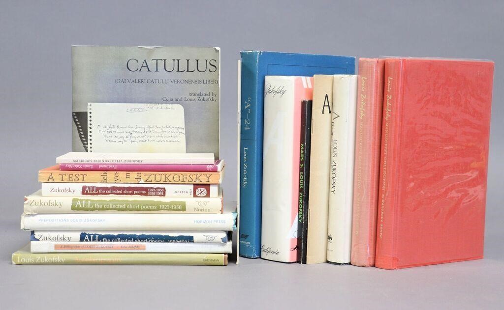 A stack of books next to a row of books written by Louis Zukofsky.