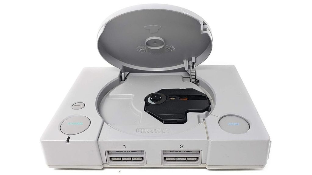 Sony 32-bit PlayStation video game console from 1995 displayed with its game disc cover open.