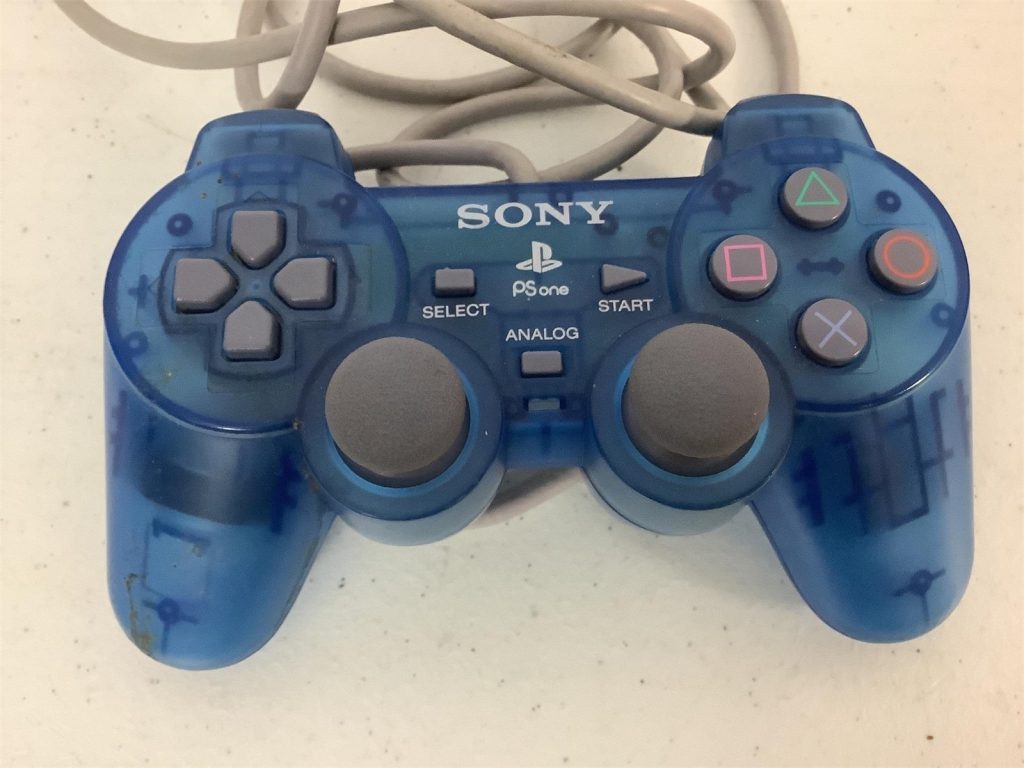 Blue Sony Playstation 1 analog video game controller.